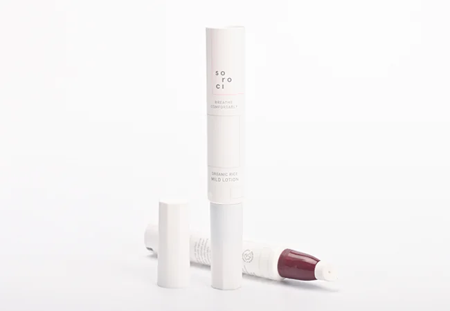 Slim white cosmetic tube with its cap removed