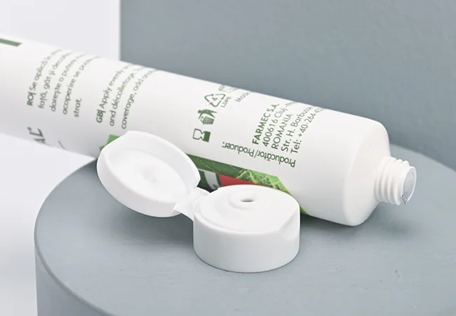 White cosmetic tube showing its flip-top closure